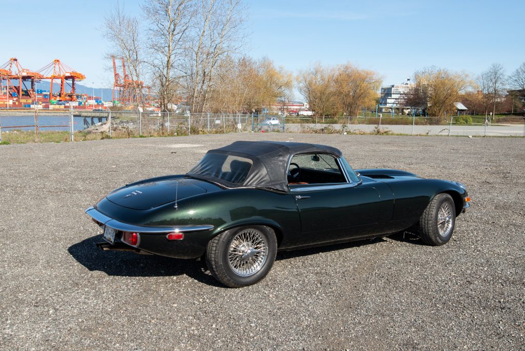 1974 Jaguar E-Type opalescent green rear passenger soft top up
