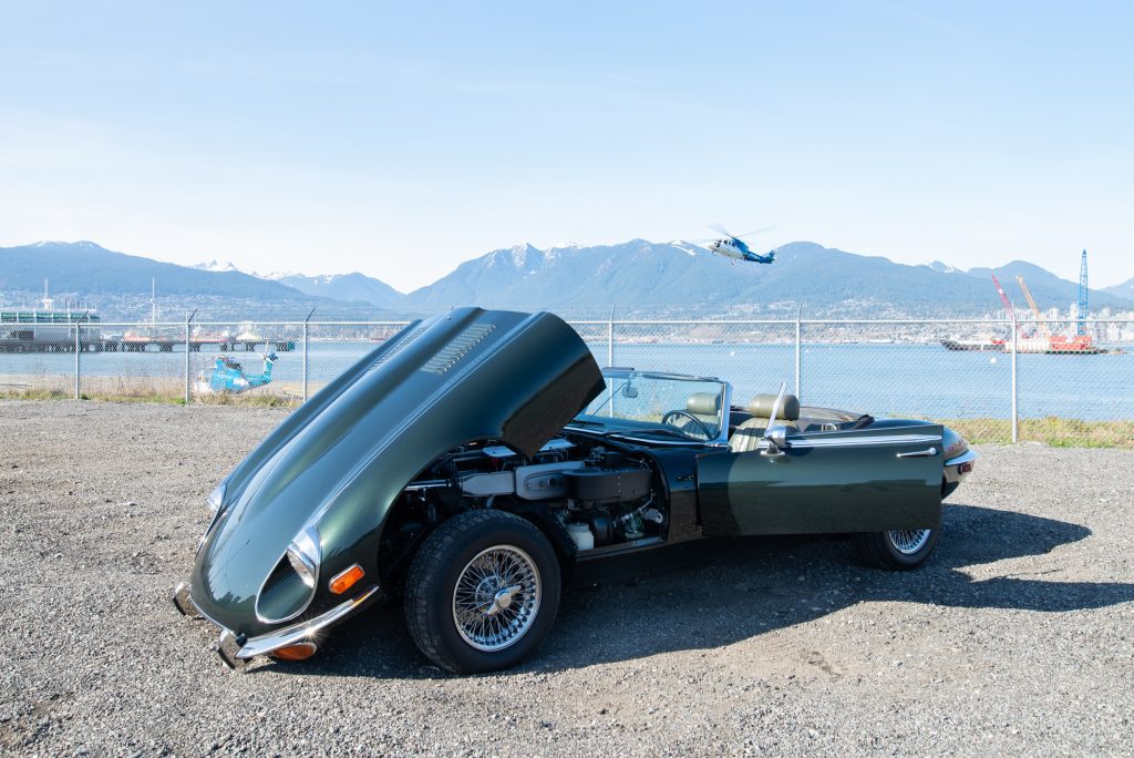 1974 Jaguar E-Type opalescent green hood open right passenger side door open
